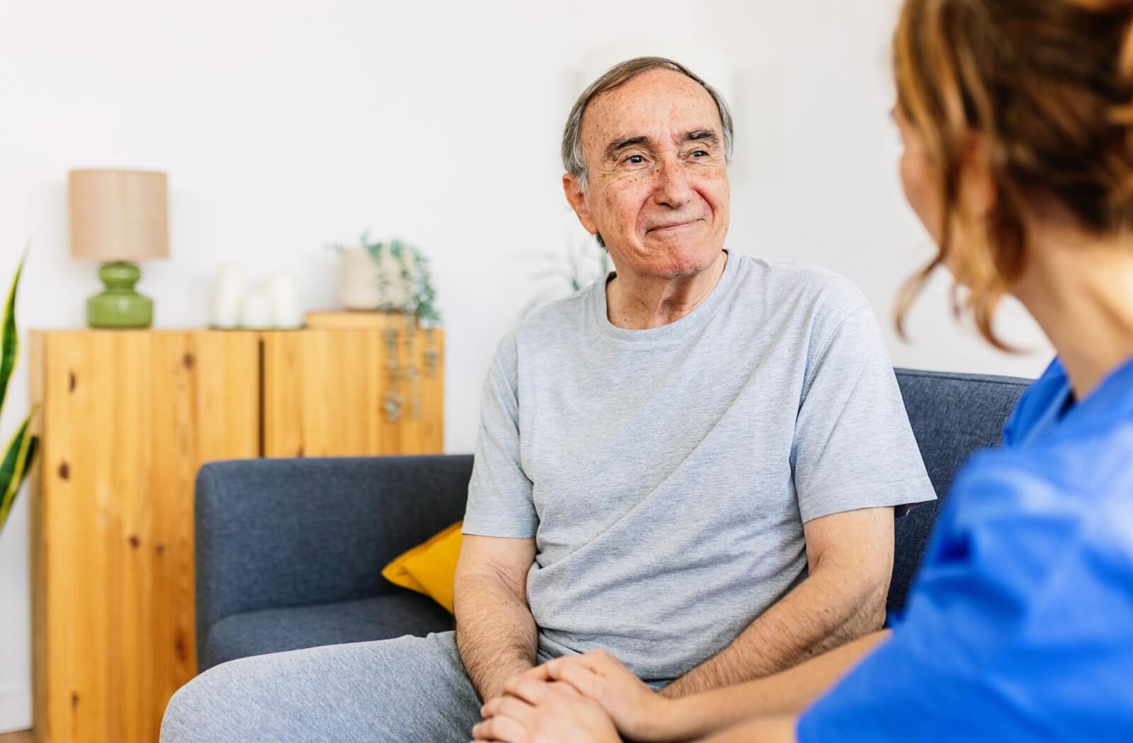 Senior in assisted living getting support from nurse.